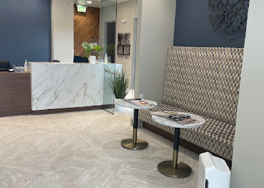 Front desk and two end tables in reception area of Meridian dental office
