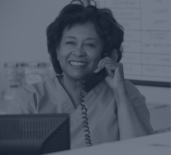 Meridian dental team member sitting at desk and answering the phone