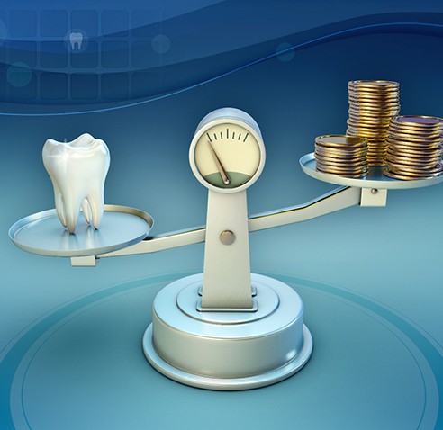 Tooth and coins on a balance scale