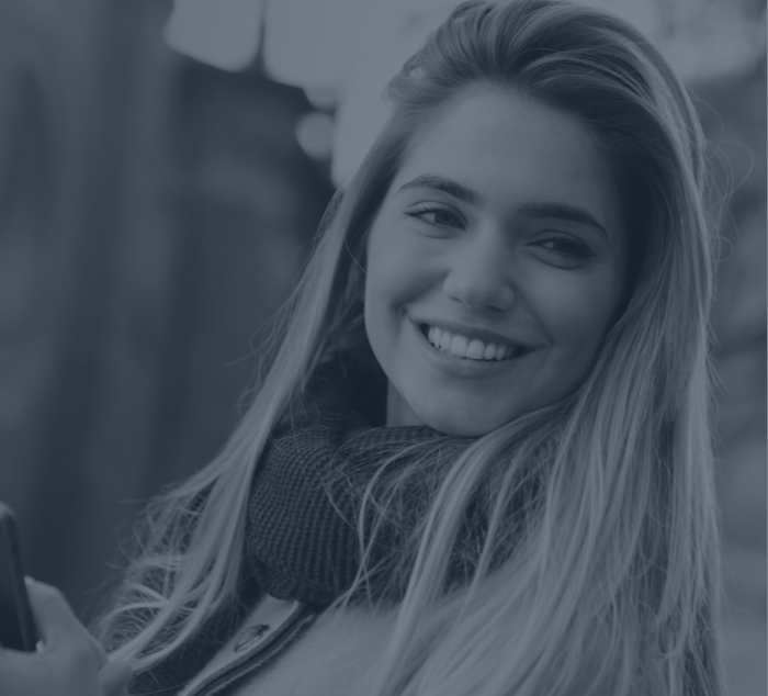 Woman in scarf smiling after cosmetic dentistry in Parker