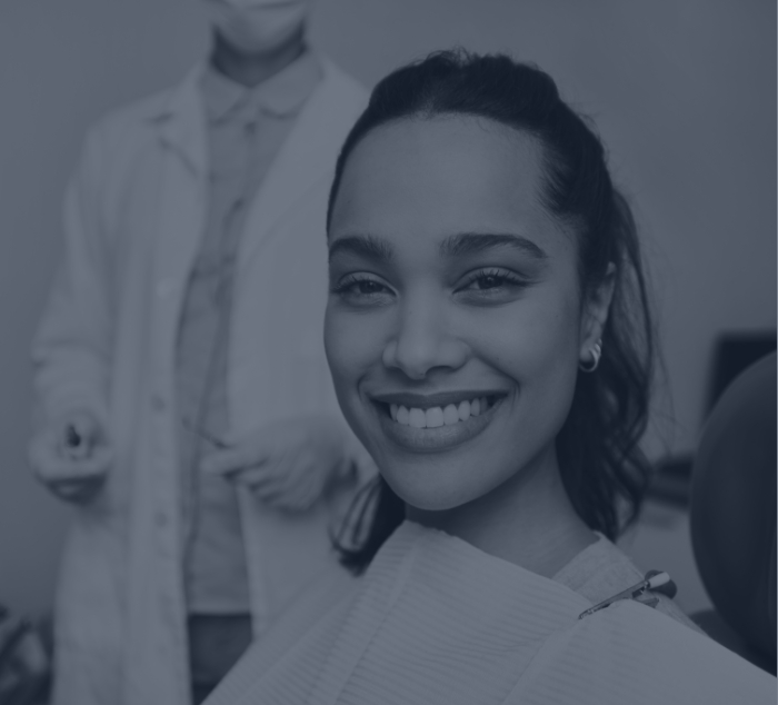 Woman grinning in dental chair while visiting Parker dentist
