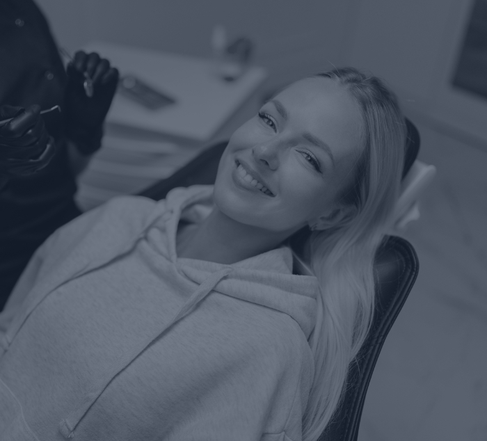Smiling woman leaning back in dental chair in Parker dental office