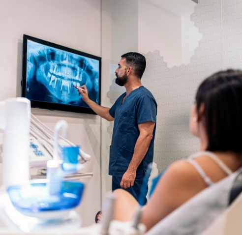 Dentist showing a patient x rays of their teeth