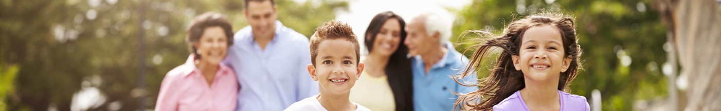 Family smiling outdoors after visiting dentist near Lone Tree