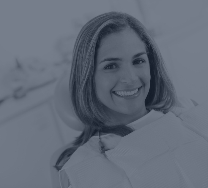 Young woman grinning in dental chair