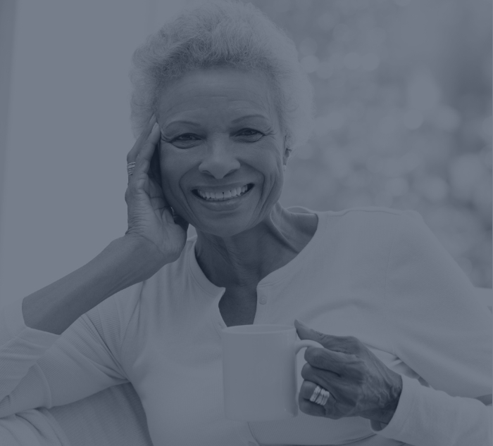 Woman holding coffee mug and smiling with veneers in Meridian