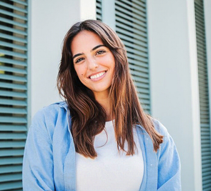 a woman smiling with a healthy and bright smile